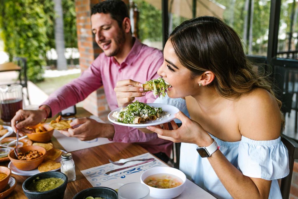NATL_Pic_Dining_Restaurant_Outdoor_Patio_Couple_Mexican_Food_Stock_Adobe_463508552