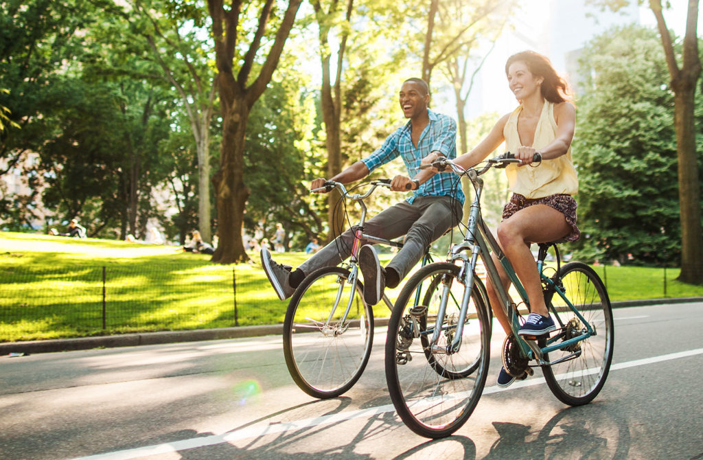 couple-riding-bikes-in-sun